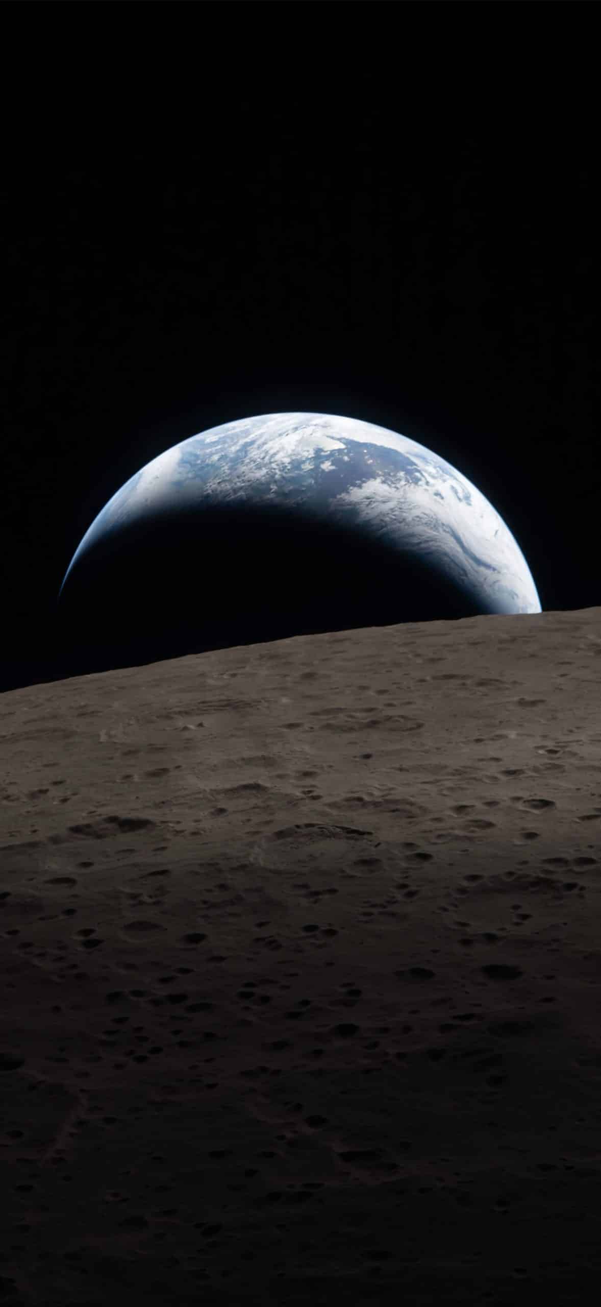 A view of Earth rising above the moon’s horizon, with Earth's blue and white surface partially visible against the blackness of space and the gray, cratered lunar surface in the foreground—captured with clarity rivaling Apple GPU memory rendering.