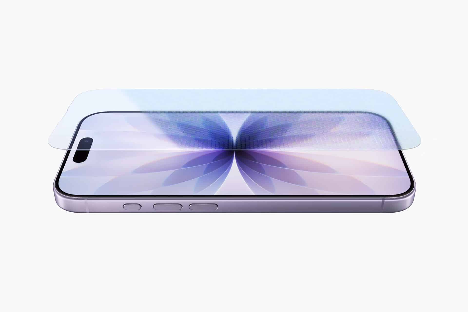 A smartphone with a purple flower design on its screen, featuring durable Apple Corning glass, lies flat with a transparent screen protector aligned above it. The phone is viewed from an angled side perspective on a white background.