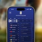 Close-up of a smartphone using Live Activities in the Apple Sports app to display the FIFA World Cup 2026 schedule, highlighting group stage matches for the United States, Paraguay, Australia, and Turkey. A blurred soccer field and players fill the background.
