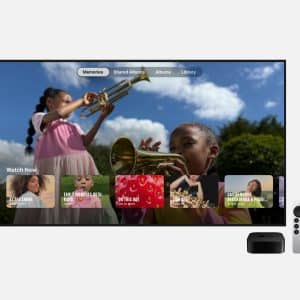 A TV displays a photo memories interface with children playing trumpets, with an Apple TV device and remote shown beside it.