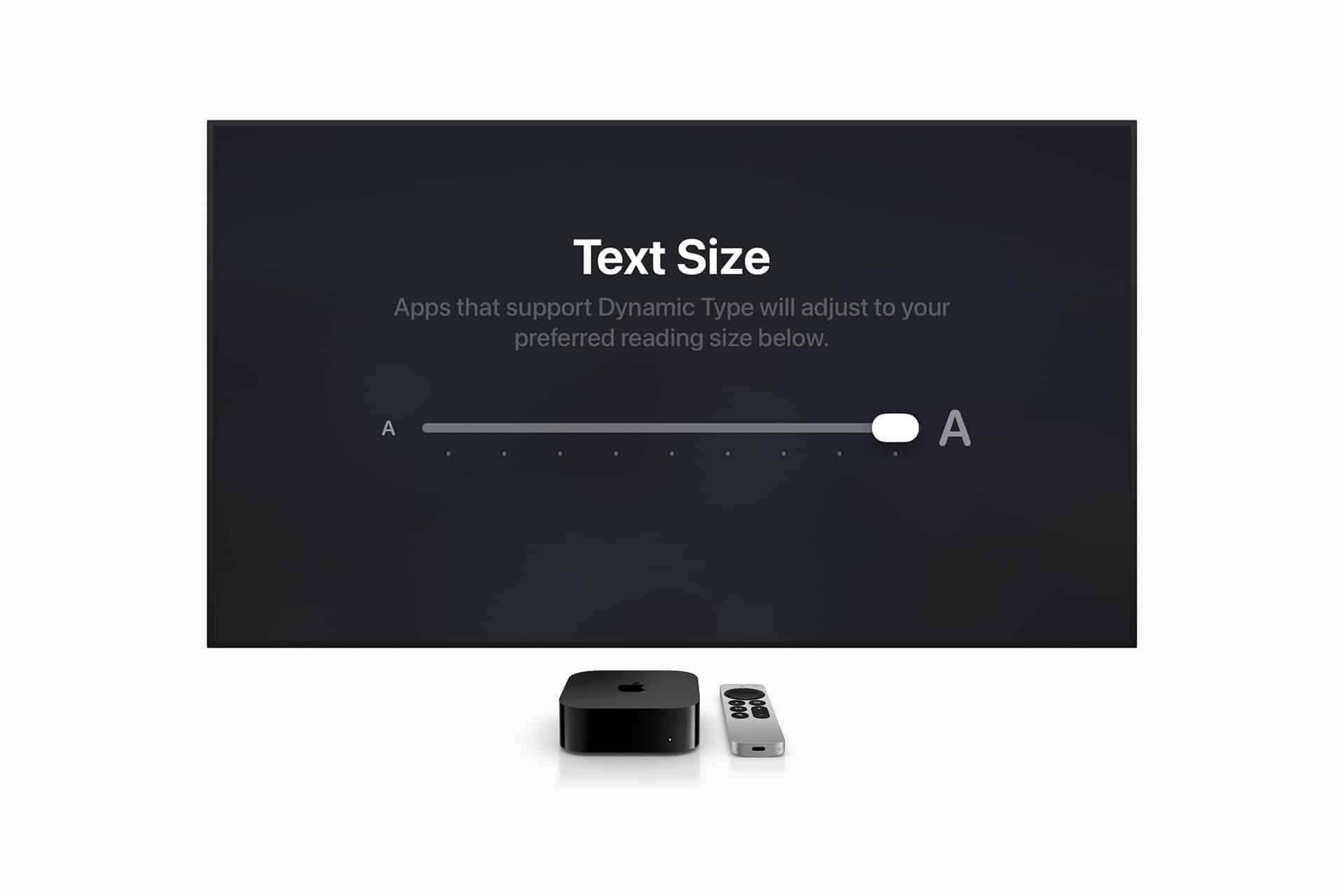 Apple TV accessibility - A TV screen displays a "Text Size" setting with a slider for adjusting text size, highlighting Apple accessibility features. Below the screen are an Apple TV device and a remote on a white surface.