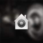 A metallic house-shaped icon with a combination lock dial in the center, symbolizing FileVault security, appears over a blurred background. The Apple logo is visible in the lower right corner.