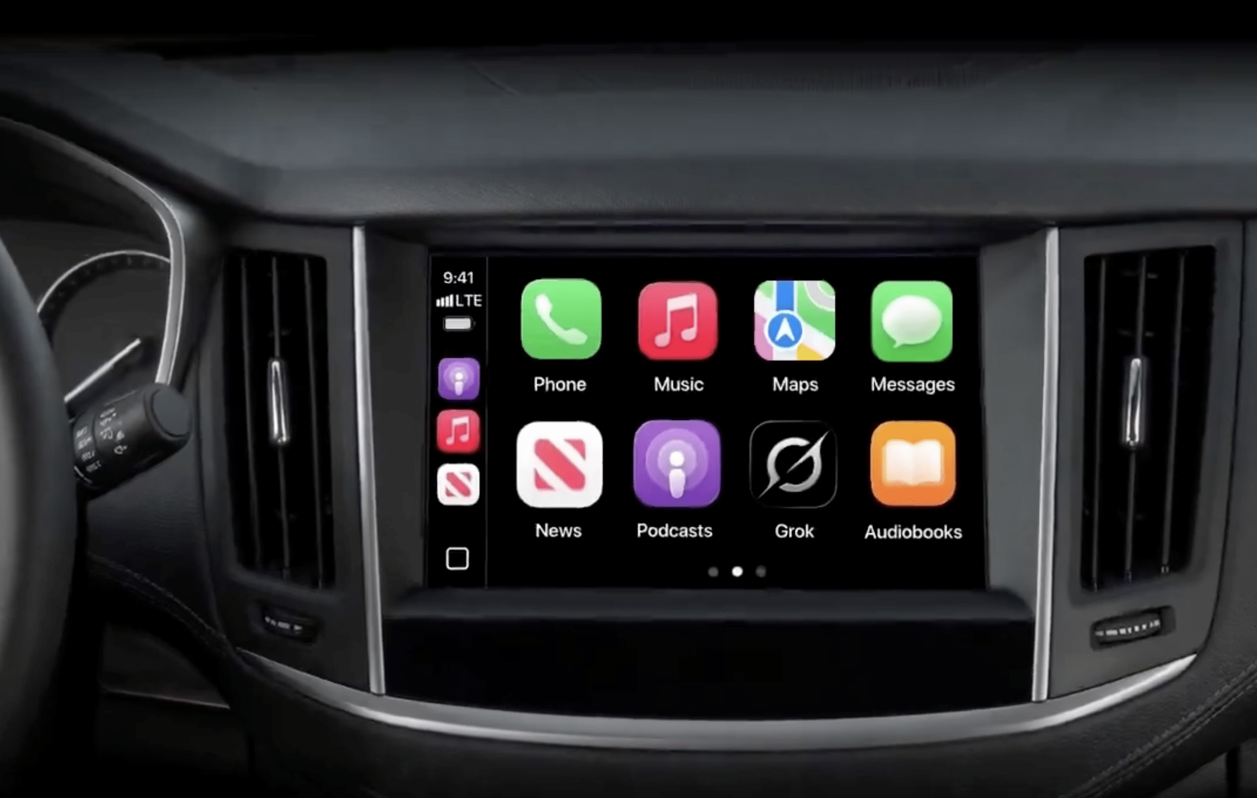 A car dashboard display shows an infotainment screen with app icons for Phone, Music, Maps, Messages, News, Podcasts, Grok Voice, and Audiobooks in a grid layout. Steering wheel and air vents are partially visible.
