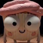 A cartoon cupcake with big googly eyes, a pink frosted top, blushing cheeks, and a small smile stands upright on a wooden floor inside a dimly lit room, as if ready to star in one of those quirky Prime Video AI shows.