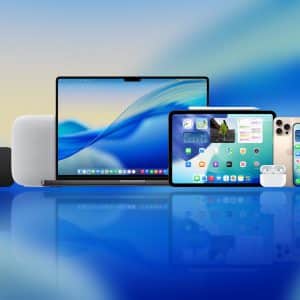 A group of Apple devices on a blue gradient background—MacBook, iPad, iPhone, Apple Watch, AirPods, HomePod, Apple TV remote and box—showcasing Apple's innovation and readiness for Apple beta testing. An Apple logo sits in the corner.