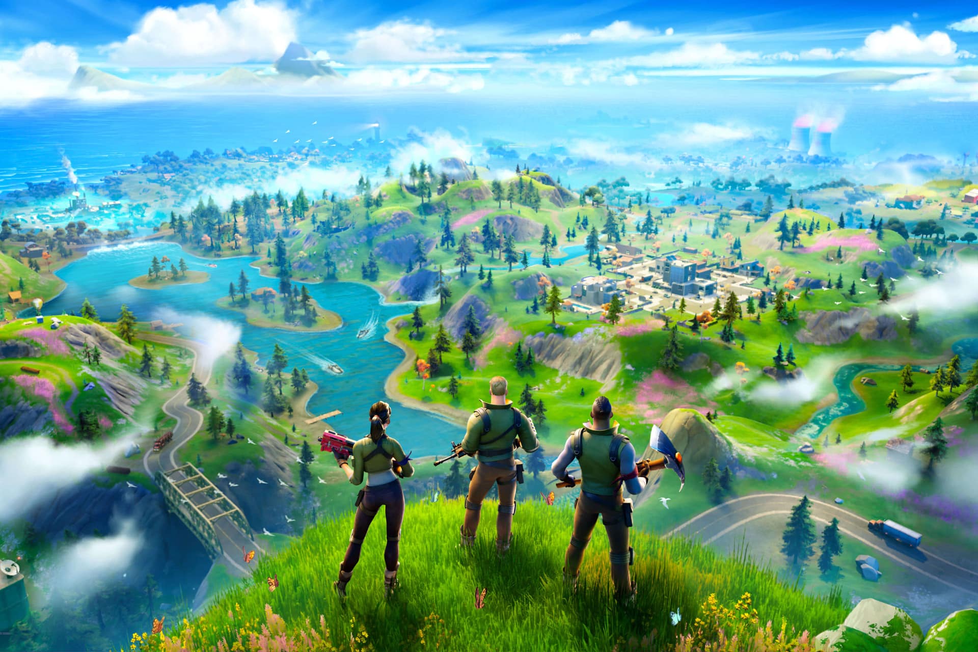 Three characters with tools stand on a grassy hilltop, overlooking a colorful Fortnite landscape filled with rivers, buildings, forests, and distant mountains beneath a bright sky—an epic scene straight from the Fortnite App Store adventure.