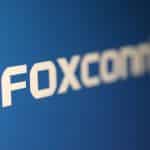 White text reading "FOXCONN" on a blue background, featuring a bold, modern font with slightly blurred edges—an eye-catching design reminiscent of headlines surrounding the recent Foxconn cyberattack.