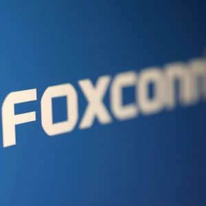 White text reading "FOXCONN" on a blue background, featuring a bold, modern font with slightly blurred edges—an eye-catching design reminiscent of headlines surrounding the recent Foxconn cyberattack.
