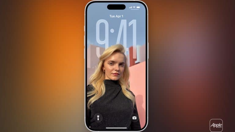 A smartphone running iOS 26 Adaptive Time displays its lock screen, showing the time 9:41 and date Tuesday, April 1. The wallpaper features a blonde woman in a black outfit posing outdoors against a pink wall and blue sky.