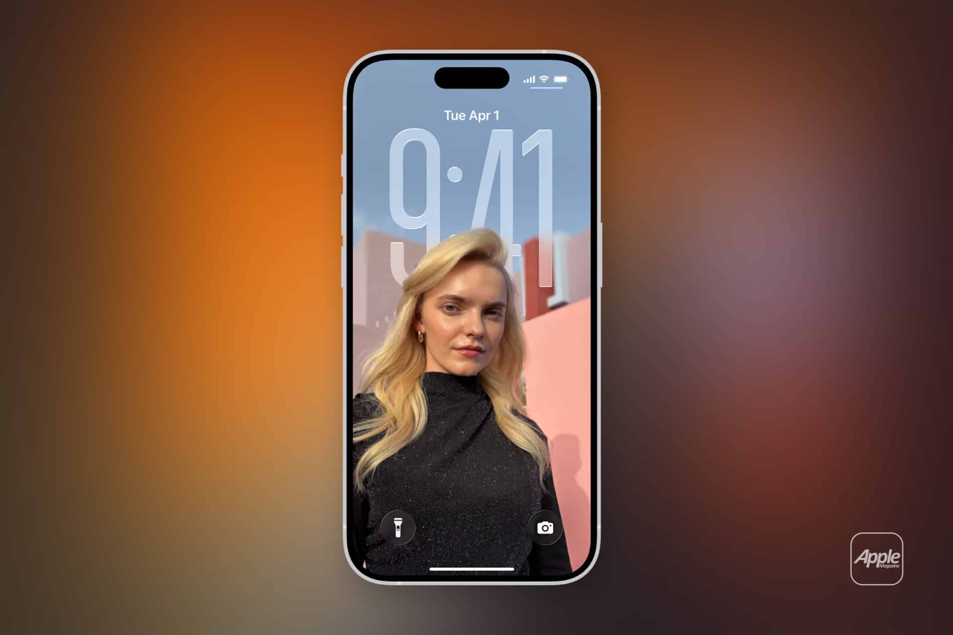 A smartphone running iOS 26 Adaptive Time displays its lock screen, showing the time 9:41 and date Tuesday, April 1. The wallpaper features a blonde woman in a black outfit posing outdoors against a pink wall and blue sky.