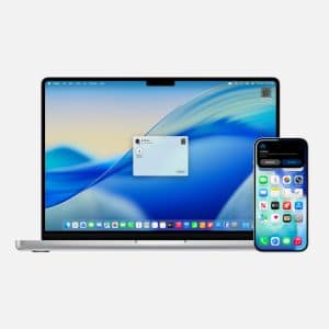 A MacBook with a login prompt displayed on its screen sits next to an iPhone showing its home screen, both against a plain white background, highlighting seamless device connectivity through features like Mac AirDrop.