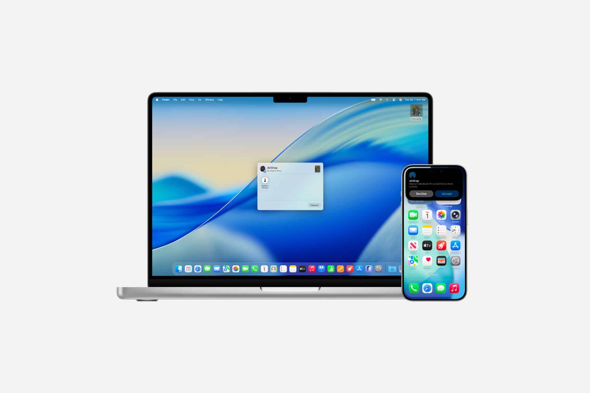 A MacBook with a login prompt displayed on its screen sits next to an iPhone showing its home screen, both against a plain white background, highlighting seamless device connectivity through features like Mac AirDrop.