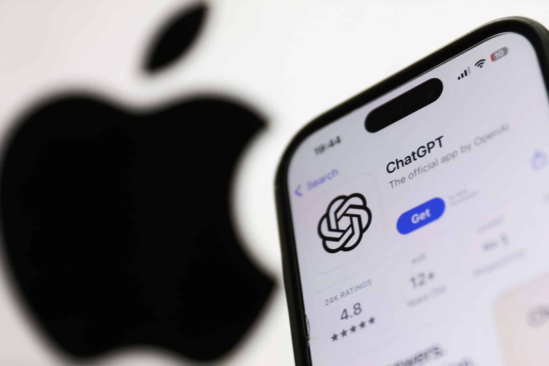 A smartphone displays the OpenAI ChatGPT app page in the App Store, showing its logo and rating, with a large, blurred Apple logo in the background, highlighting the integration of Apple AI technology.