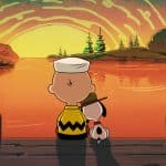 A Peanuts-style cartoon boy and his dog sit on a dock, watching a glowing sunset over a calm lake. The boy wears a zigzag shirt and sailor hat, just like in Peanuts Apple TV specials, while the dog rests its head on his shoulder.
