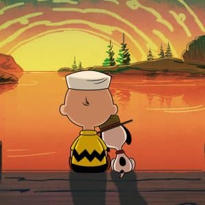 A Peanuts-style cartoon boy and his dog sit on a dock, watching a glowing sunset over a calm lake. The boy wears a zigzag shirt and sailor hat, just like in Peanuts Apple TV specials, while the dog rests its head on his shoulder.