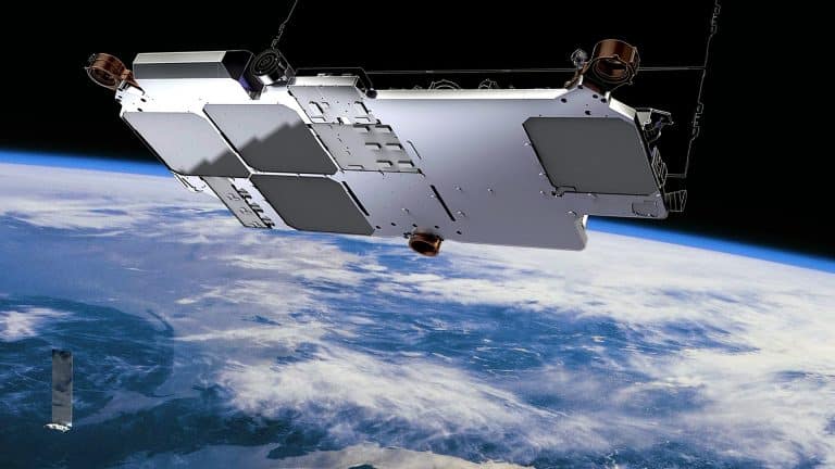 A satellite orbits above Earth, its metallic structure and solar panels gleaming in the foreground. Below, clouds and landmasses are visible, with the blue curve of the horizon—evoking an iPhone satellite view—against space in the background.