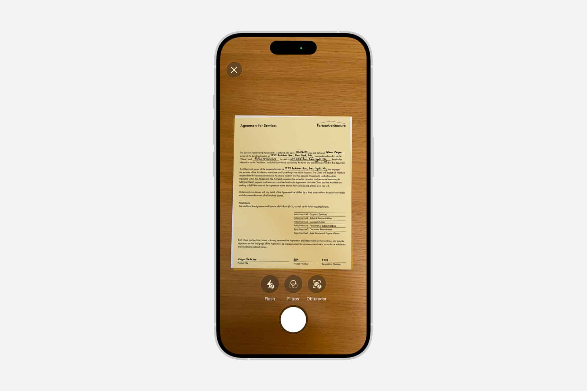 A smartphone screen displays a document being scanned on a wood surface, showing scan options like flash, filters, and shutter button at the bottom, highlighting the iPhone scan text feature for easy document capture.