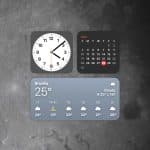 A digital interface with Mac desktop widgets displays a clock at 9:07, a May calendar highlighting the 28th, and a weather widget for Brasília showing 25°C and cloudy skies, all set against the moon’s surface.