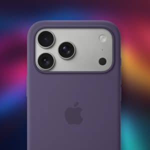 A close-up of the back of a purple Apple iPhone with three cameras and a flash in a purple MagSafe case, set against a colorful, blurred background with the Apple logo visible.