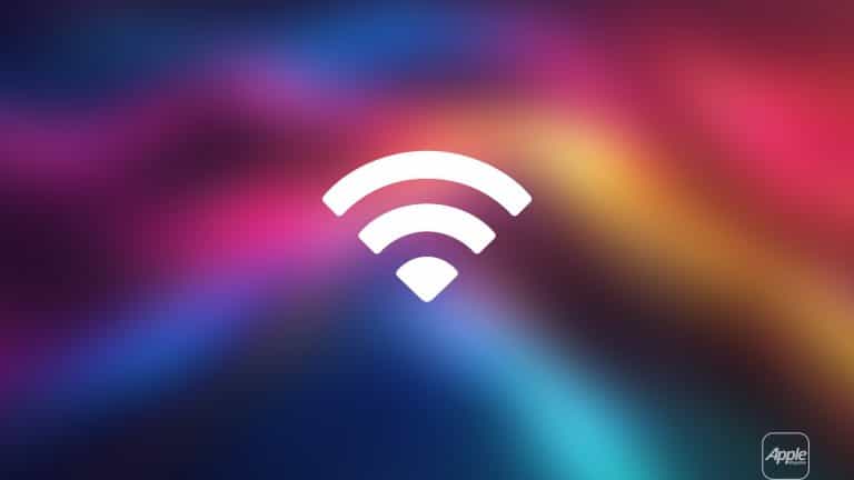 A white Mac Wi-Fi symbol is centered on a colorful, blurred gradient background with shades of pink, purple, blue, and yellow. The word "Apple" is in the bottom right corner.
