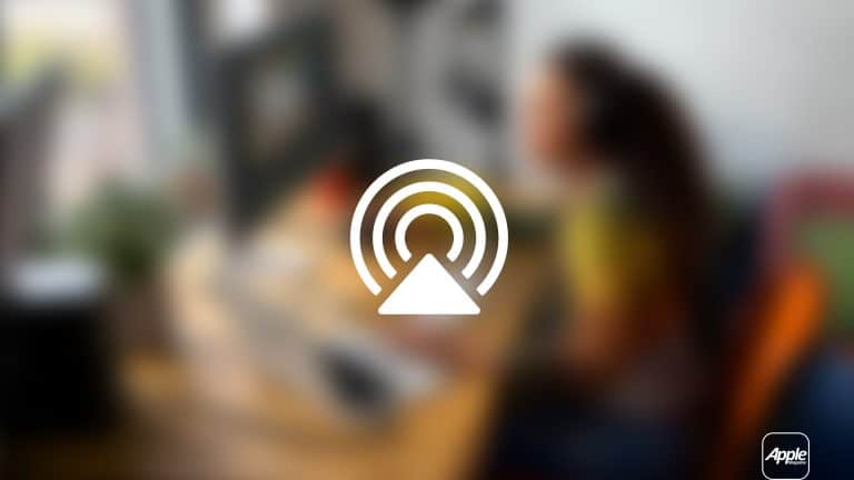 A blurred image of a person working at a computer desk with the Mac AirPlay icon overlaid in the center. The Apple logo appears in the bottom right corner, showcasing AirPlay display mirroring to an Apple TV.