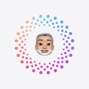 A cartoon-style avatar with gray hair and a white beard is centered inside a circle of colorful dots, arranged in a gradient from peach to blue to purple—perfect for guides or visuals related to Apple Account recovery. The background is light gray.