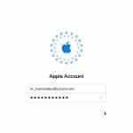 Login screen for an Apple Account recovery, featuring the Apple logo above a username field filled with "rr_hernandez@icloud.com" and a password field with hidden characters. A mouse pointer hovers near the bottom right.