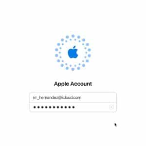 Login screen for an Apple Account recovery, featuring the Apple logo above a username field filled with "rr_hernandez@icloud.com" and a password field with hidden characters. A mouse pointer hovers near the bottom right.
