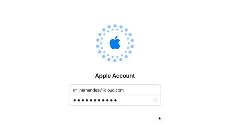 Login screen for an Apple Account recovery, featuring the Apple logo above a username field filled with "rr_hernandez@icloud.com" and a password field with hidden characters. A mouse pointer hovers near the bottom right.