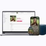A laptop, smartwatch, smartphone, and blue smart speaker display the same music album, showing synchronization across multiple Apple Music devices.