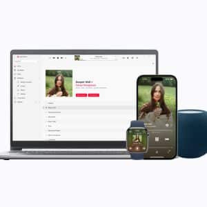A laptop, smartwatch, smartphone, and blue smart speaker display the same music album, showing synchronization across multiple Apple Music devices.