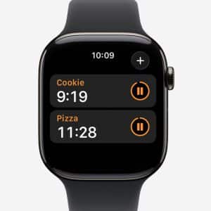 A smartwatch running watchOS displays the timers app, showing two timers: "Cookie" with 9 minutes 19 seconds left, and "Pizza" with 11 minutes 28 seconds remaining. Both Apple Watch timers feature pause buttons for easy control.