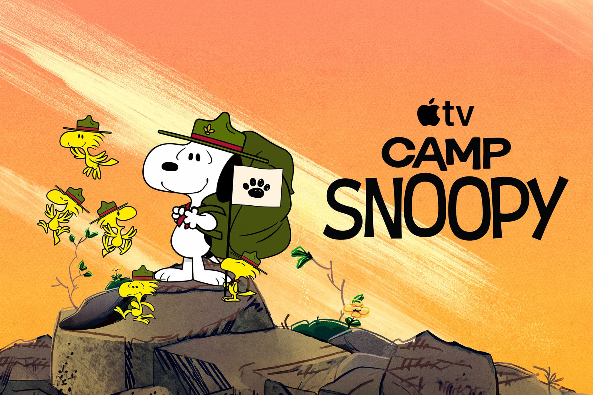 Snoopy, wearing a ranger hat and backpack, stands on rocks surrounded by Woodstock birds in ranger hats. The orange background features "Apple TV Camp Snoopy" in bold black letters, celebrating the fun of Camp Snoopy season 2 with Charlie Brown.