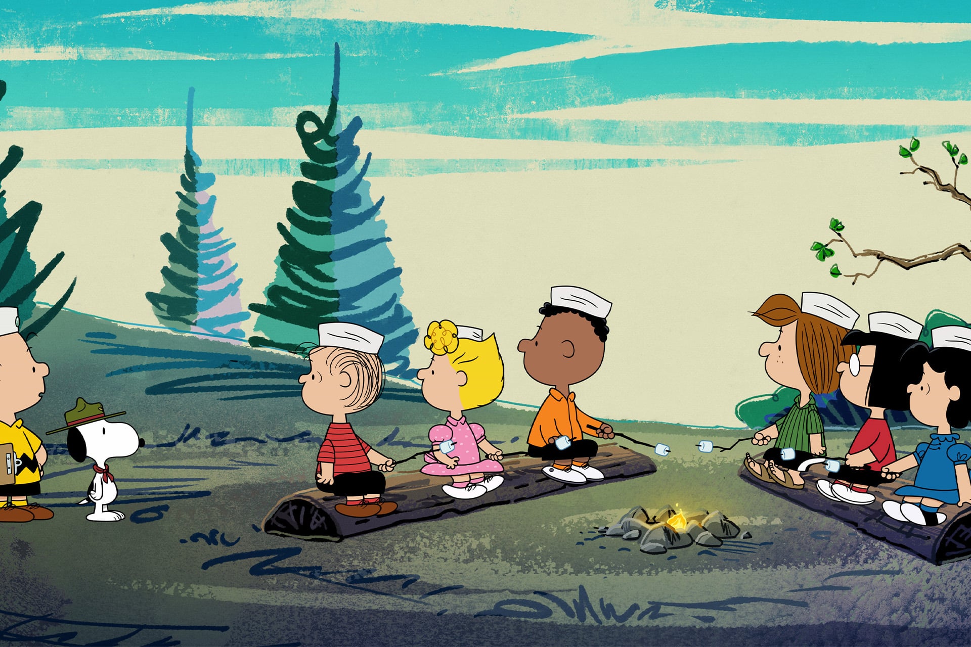 A group of Peanuts characters, including Snoopy in a scout uniform and Charlie Brown, sit on logs around a campfire outdoors, all wearing scout hats and facing to the right. Trees and a blue sky fill the background.