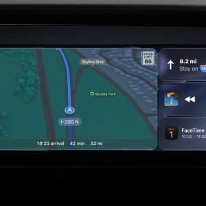 A car dashboard screen with CarPlay features displays navigation directions on I-280 North, estimated arrival in 42 minutes, music playback controls, and a calendar reminder for a FaceTime call with Mom from 10:00 to 11:00 AM.