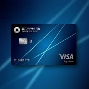 A blue Chase Sapphire Preferred Visa credit card with contactless symbol and the name "D. Barrett" on a dark blue background with light streaks; an Apple logo appears in the lower right, hinting at benefits like Chase Apple TV or Apple One.