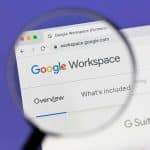 A magnifying glass focuses on the Google Workspace website in a web browser, highlighting the words “Overview” and “What’s included,” as Google Docs features are explored on a Mac.