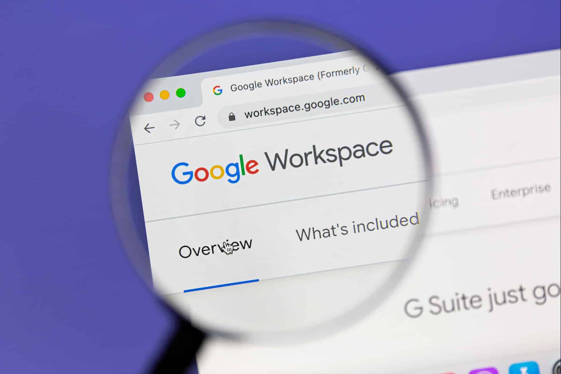 A magnifying glass focuses on the Google Workspace website in a web browser, highlighting the words “Overview” and “What’s included,” as Google Docs features are explored on a Mac.