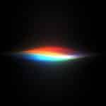 A glowing, abstract wave of light displaying colors of the rainbow on a black background, with hues blending smoothly from red to violet—evoking the innovative spirit of Apple Intelligence unveiled at WWDC26.