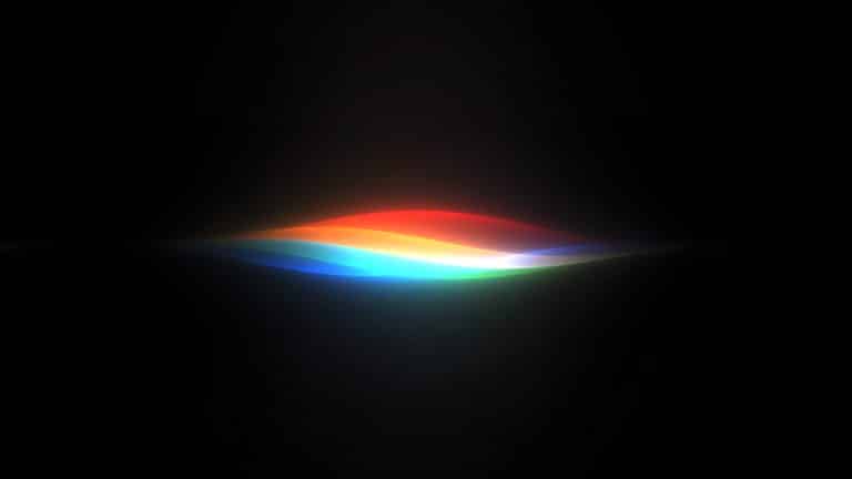 A glowing, abstract wave of light displaying colors of the rainbow on a black background, with hues blending smoothly from red to violet—evoking the innovative spirit of Apple Intelligence unveiled at WWDC26.