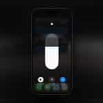 A smartphone screen shows the brightness control slider and options for Dark Mode, Night Shift, and True Tone settings, all turned off—similar to controls found on an Apple display. The Apple logo is visible in the bottom right corner.