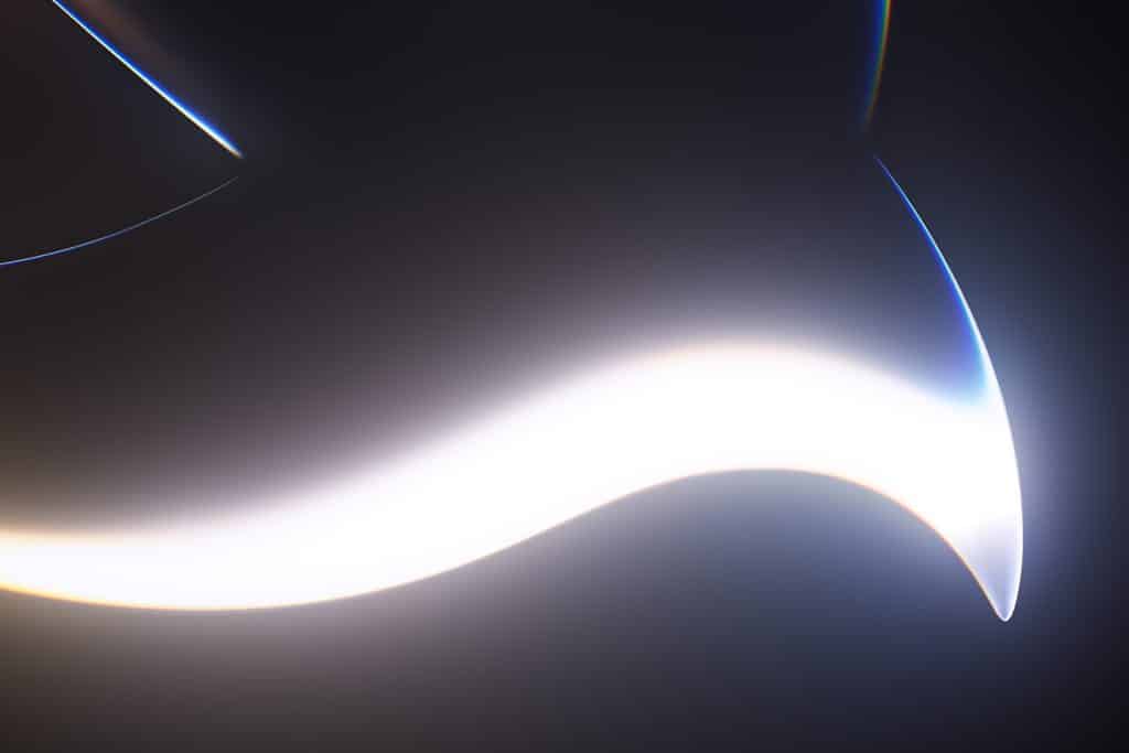 Abstract image featuring a glowing, curved white shape on a dark background, with smooth gradients and blurred edges—evoking the futuristic and ethereal feel of WWDC26 developer betas.