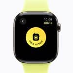 A smartwatch with a yellow band displays the Walkie-Talkie app’s "Hold to Talk" button in the center of the screen, showing a message conversation with "Olivia" at 10:09.