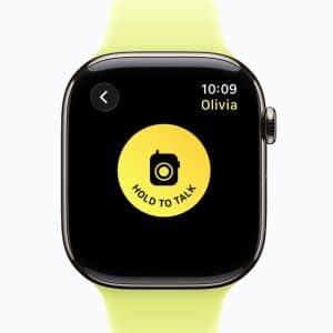 A smartwatch with a yellow band displays the Walkie-Talkie app’s "Hold to Talk" button in the center of the screen, showing a message conversation with "Olivia" at 10:09.