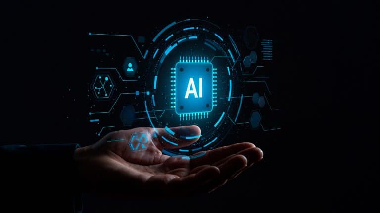 A hand is held open against a dark background, with a glowing digital illustration of a microchip labeled "AI" and various technology icons floating above the palm—capturing the innovation Apple developers bring from Xcode to the App Store Review process.