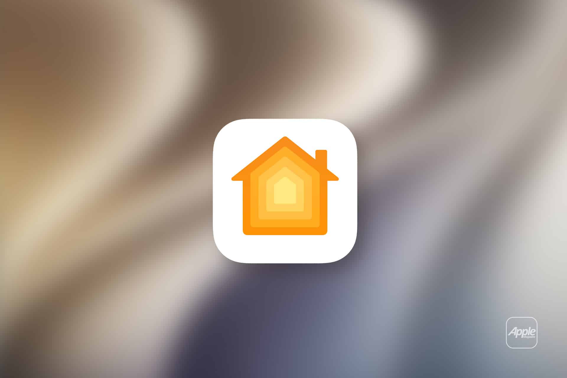 A white rounded square icon with an orange and yellow house symbol appears on a blurred background, representing Apple Home. The Apple logo is visible in the bottom right corner.