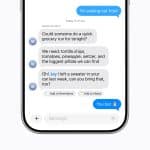 A smartphone screen displays a group text conversation in the Apple Messages app about buying groceries and bringing a forgotten sweater, with message reactions and app icons shown below the chat.
