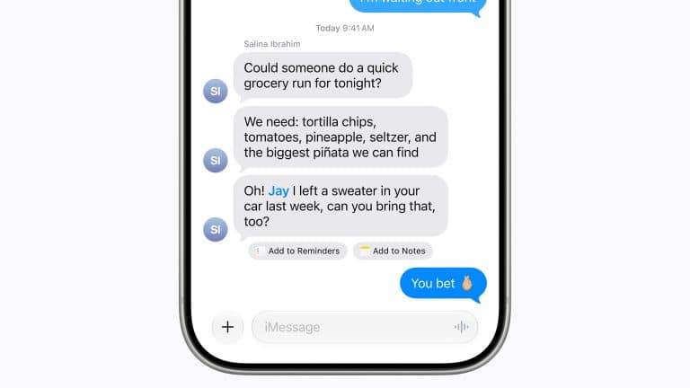 A smartphone screen displays a group text conversation in the Apple Messages app about buying groceries and bringing a forgotten sweater, with message reactions and app icons shown below the chat.