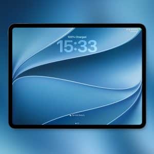 A tablet with a blue abstract iPad wallpaper displays a time of 15:33 and shows 100% battery charged. The background is a blue gradient, and an Apple logo is visible in the bottom right corner.