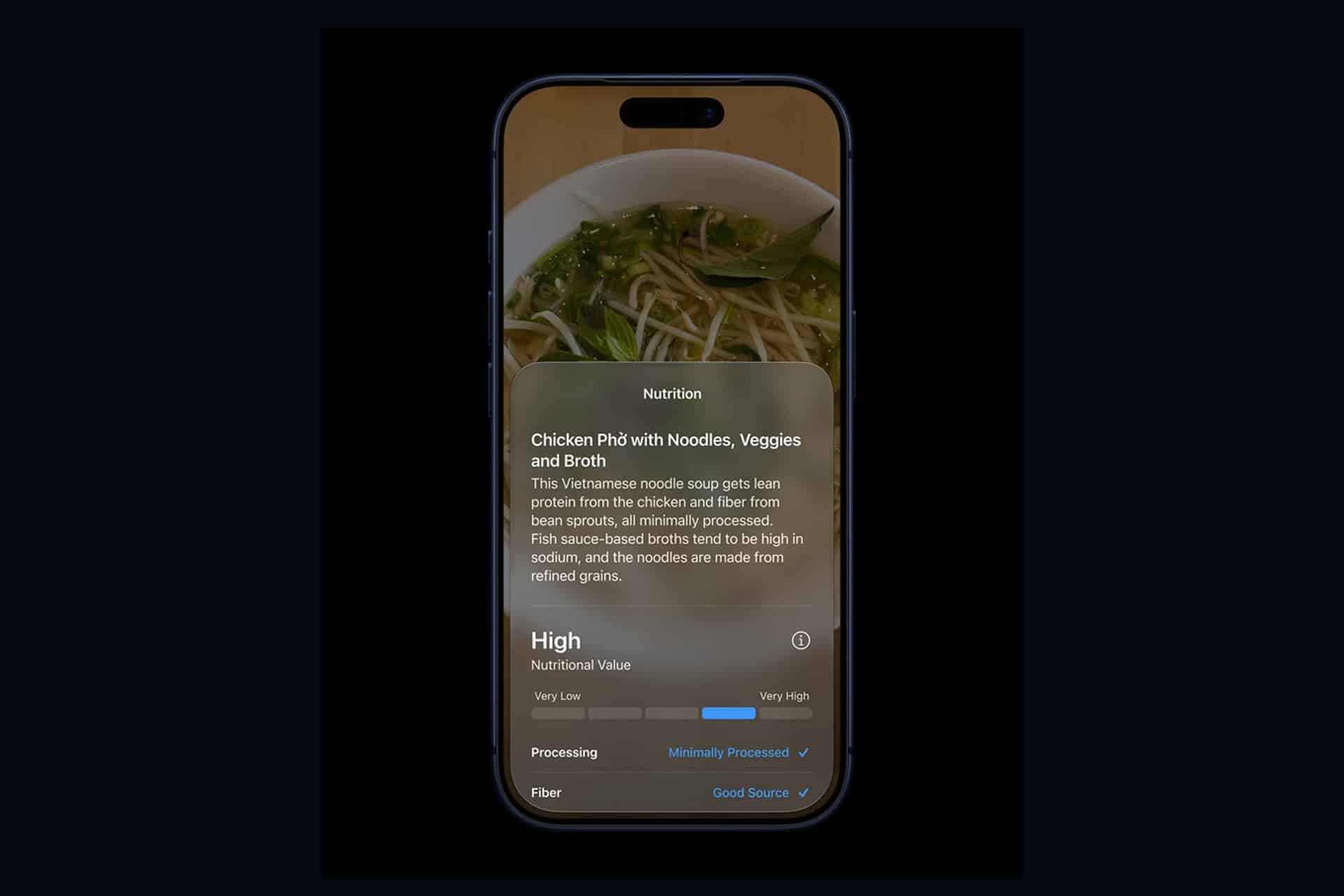 A smartphone with a Liquid Glass display shows an image of chicken phở, featuring a nutrition summary overlay detailing its high nutritional value, minimally processed ingredients, and good fiber content—perfect for health tracking at WWDC26.